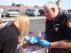 Marion General Hospital Pharmacy Intern Megan Root checks medication with Deputy Williams to classify a medication that was collected.