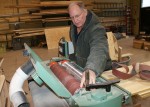 DSC08286 Tri-Rivers Career Center construction technologies instructor Steve Lawrence examines how the lightly-used belts coming from White Castle System’s PSB Company can be put to use in the belt sander his students use to smooth boards in the school’s construction technologies lab.