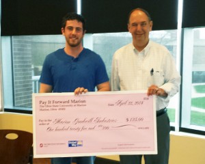 Pictured from left is English 3304 student Andrew Pinkerton and Robert Jordan Executive Director of Marion Goodwill Industries with a Pay It Forward donation of $125.