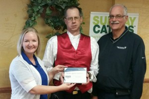 Modern Woodmen of America Representatives Kathie Seckel and Roger Ruth present Hometown Hero Award to Kenny Spafford (center).