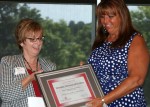 Myra Wilson, Alber Enterprise Center Director, presents award to Sandra C. Nekoloff, Executive Director of Communications and Community Relations for South-Western City Schools.