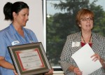 Myra Wilson, Alber Enterprise Center Director, presents award to Amy B. Boles, Training Deputy Manager for M-TEK.