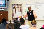 Cory Owens, a 1999 Harding High School graduate who benefitted from the Growing Our Own program, talks to students at Marion Harding High School.
