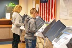 Brenda Little and Shelly Ziegler use the voting machines set up at the Marion County Board of Elections.