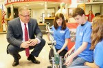 Grant Middle School robotics students Erin Rollins, Tadley Pollard and McKenzie Redmon demonstrate their robot for Marion City Schools Superintendent Gary Barber.