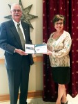 Bev Ford receives her award from Roger Ruth