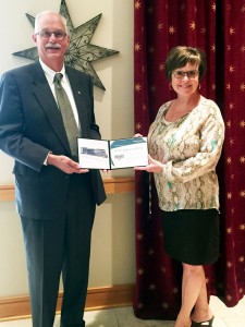 Bev Ford receives her award from Roger Ruth
