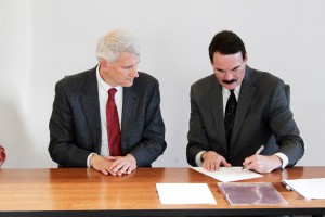 Dr. Greg Rose, of OSUM, and Dr. John Erwin, of MTC, sign the new agreement.