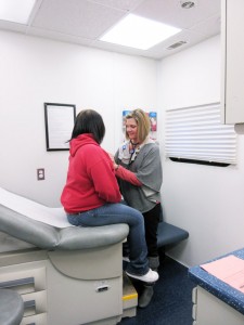 Dr. Columber of OhioHealth Marion examines a student in the Wellness on Wheels mobile unit at Rushmore Academy.