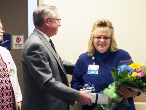 Bruce Hagen, OhioHealth Marion General Hospital President, presents Chris Myers, RN, nurse manager 2 South inpatient unit, with her 2015 Manager of the Year honors.