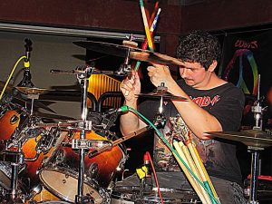 Mason playing the drums with his band, Toxic