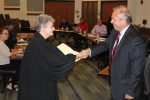 Kit Fogle swearing in: Kit Fogle is sworn in as a member of the Board of Trustees by Judge Deborah Alspach while board members look on.